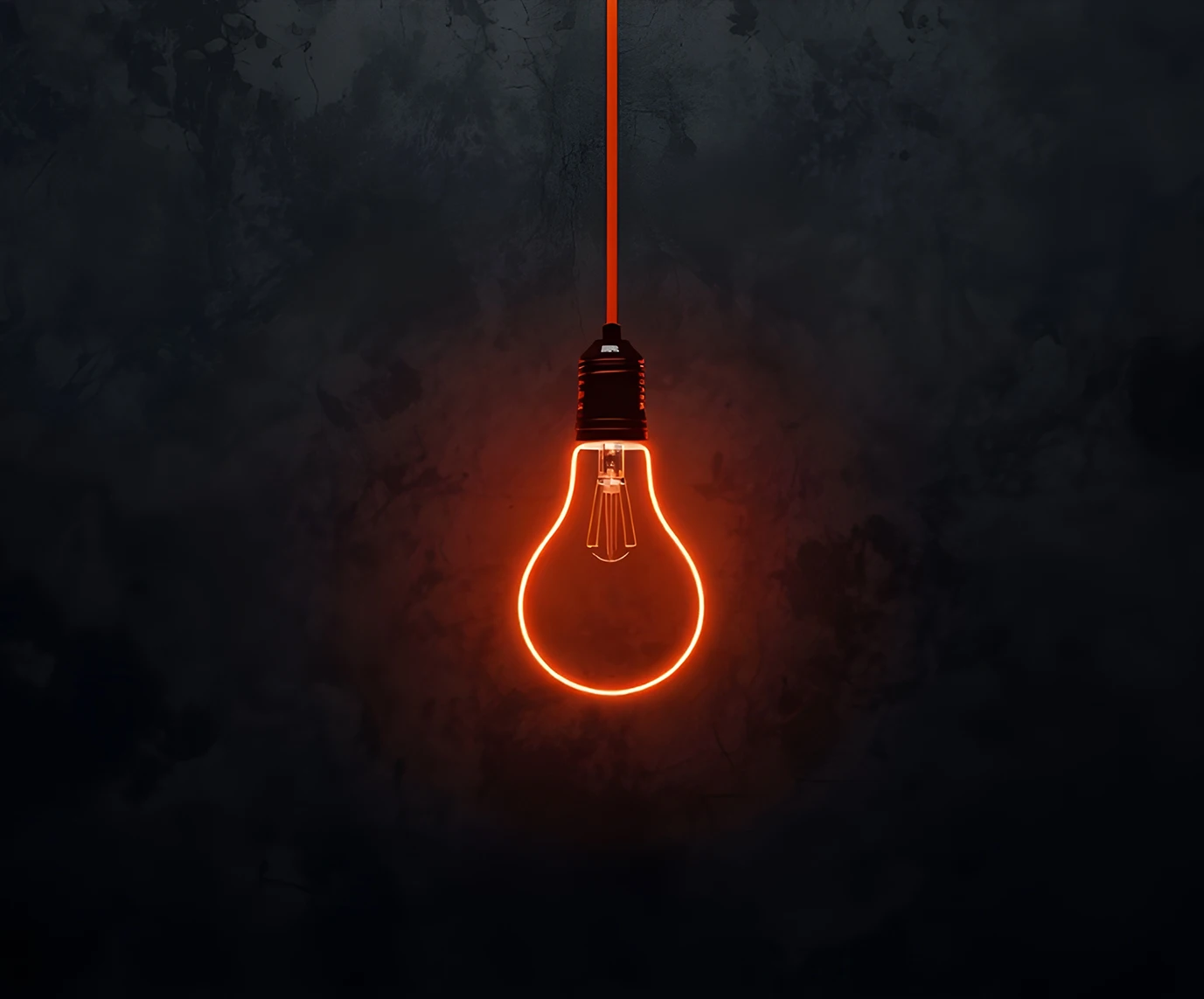 Illuminated orange light bulb hanging from a cord against a dark textured background, symbolizing an idea.